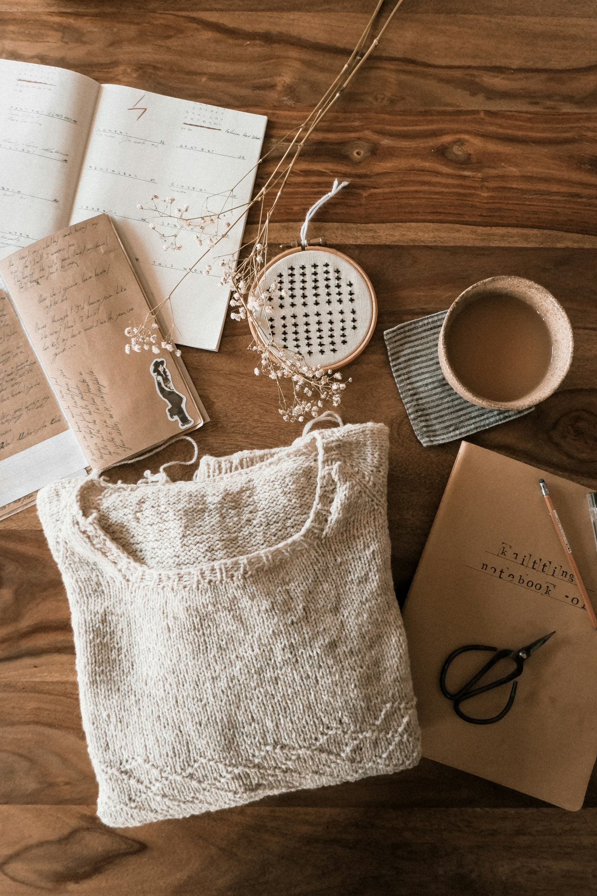 Hands crafting a knitted bag
